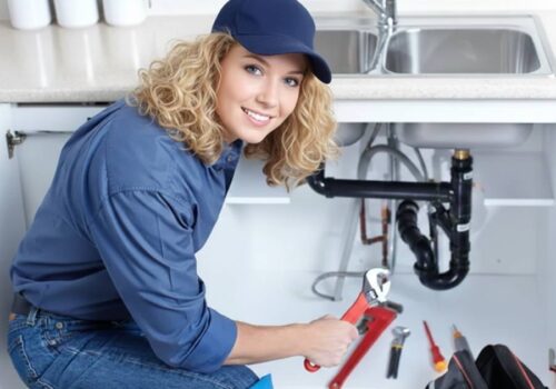 A woman plumber fixing-a leak